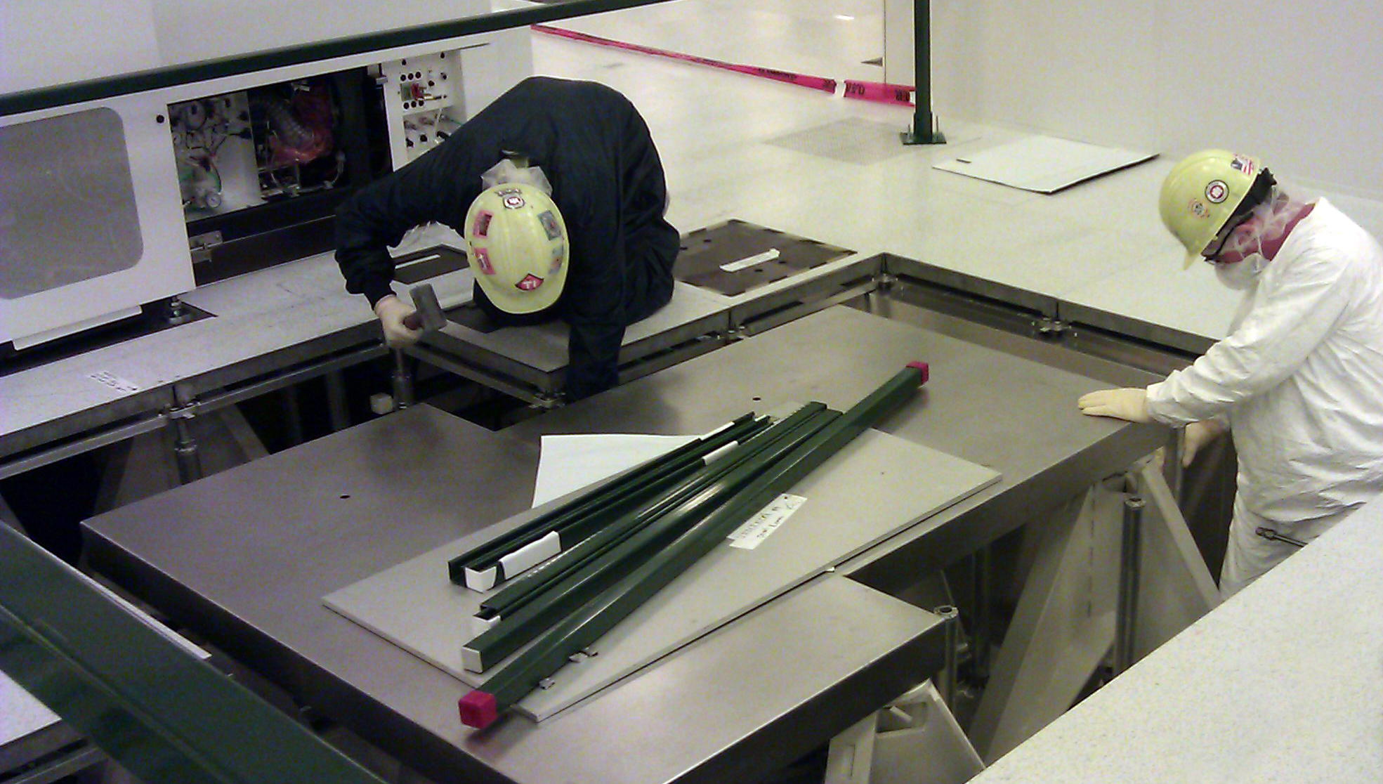 A crew installs specialty tools in a cleanroom facility