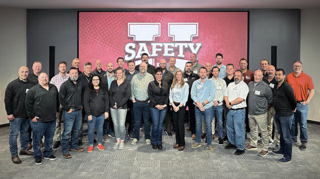 A group of construction professionals gather together after a safety training event.